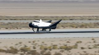 a space plane lands on a runway