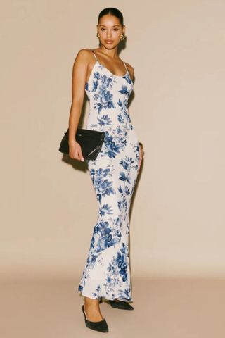 reformation winter sale woman wearing blue and white floral print maxi dress