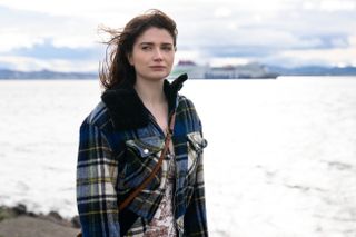 Eve Hewson as Becka Garvey, standing in front of the seas, in 'Bad Sisters.'