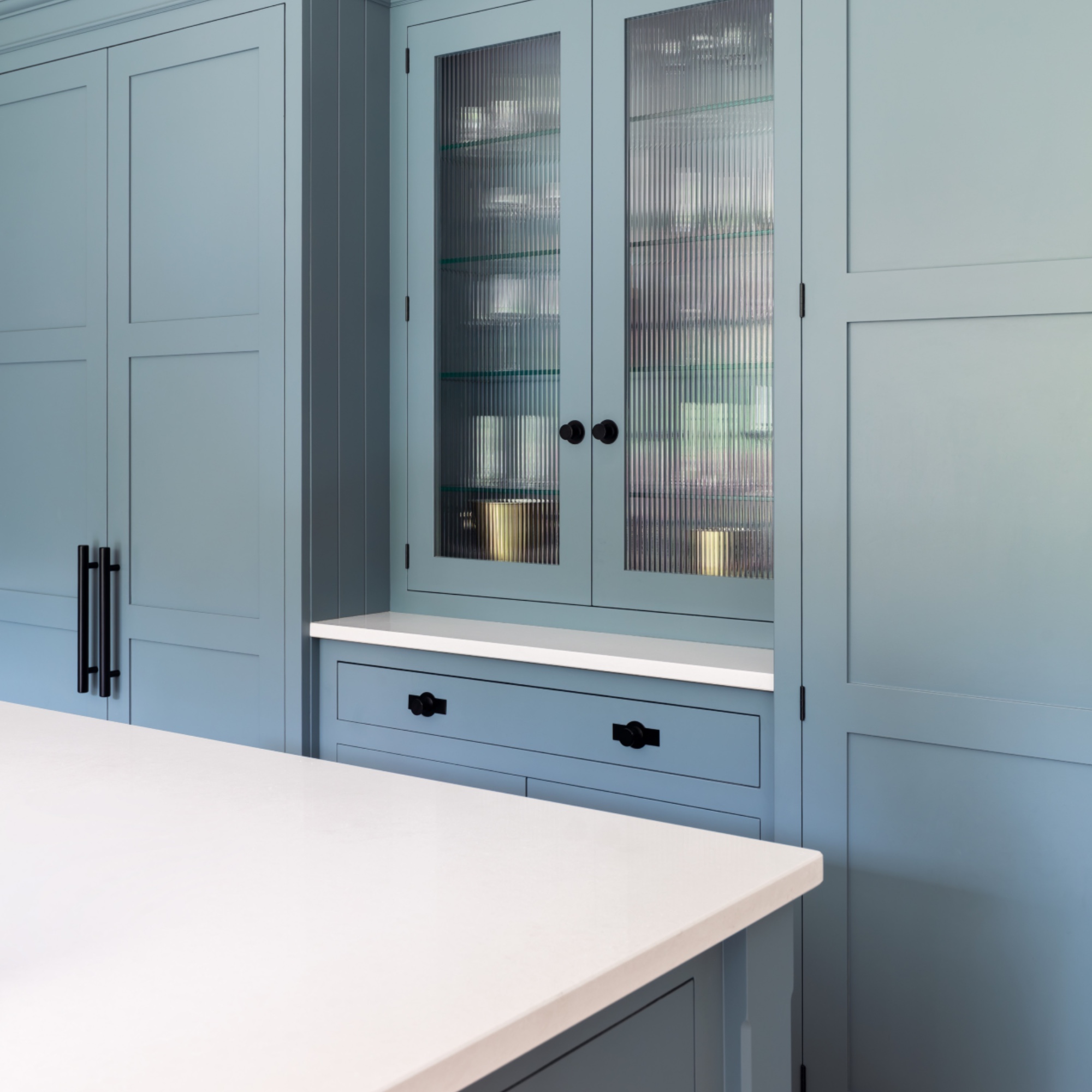 kitchen storage ideas, blue kitchen with fluted wall cabinet