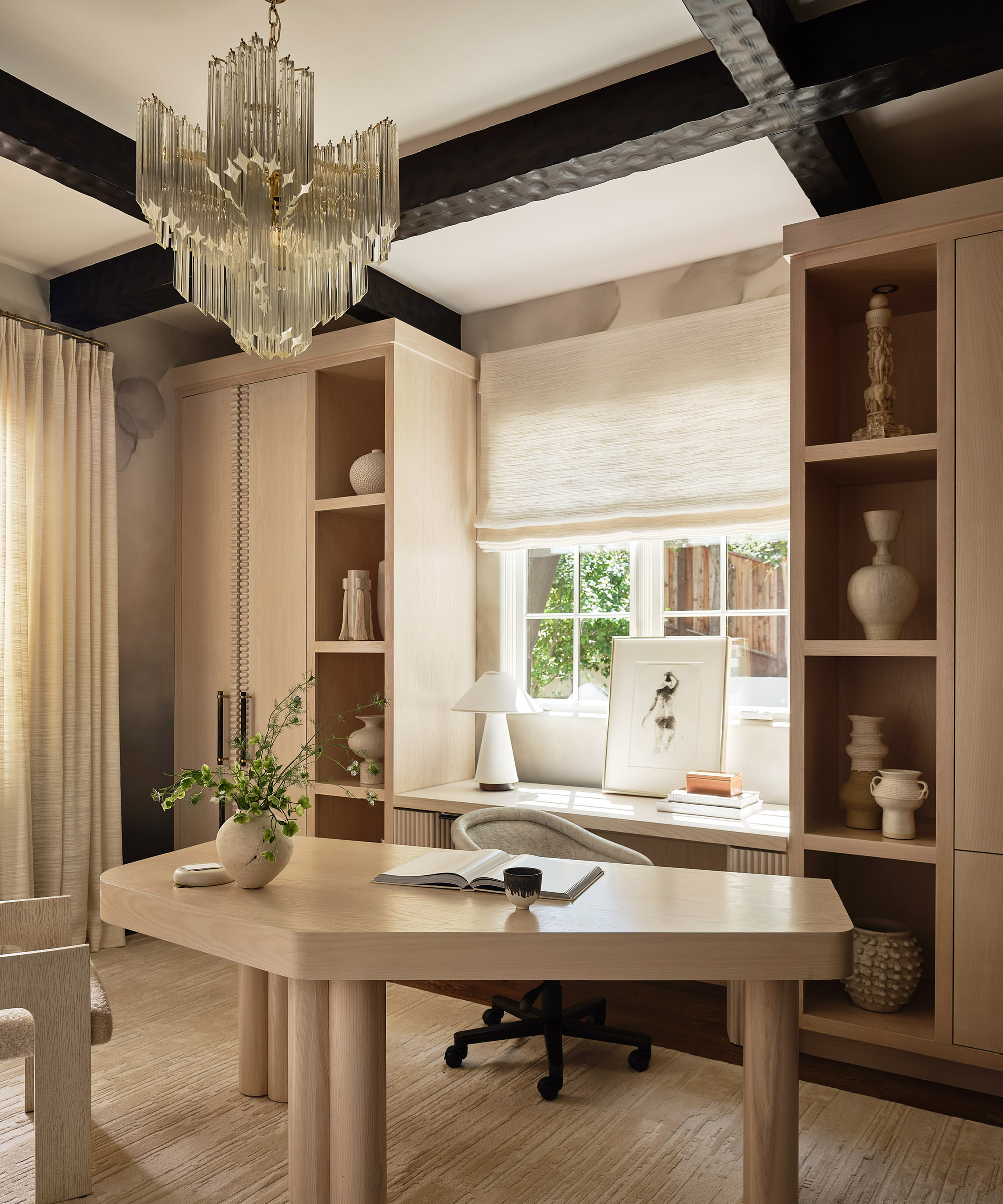 home office with modern table and glass light fitting hanging over it