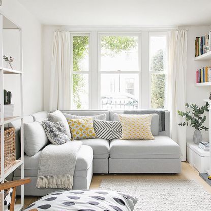 room with grey sofa and open shelve