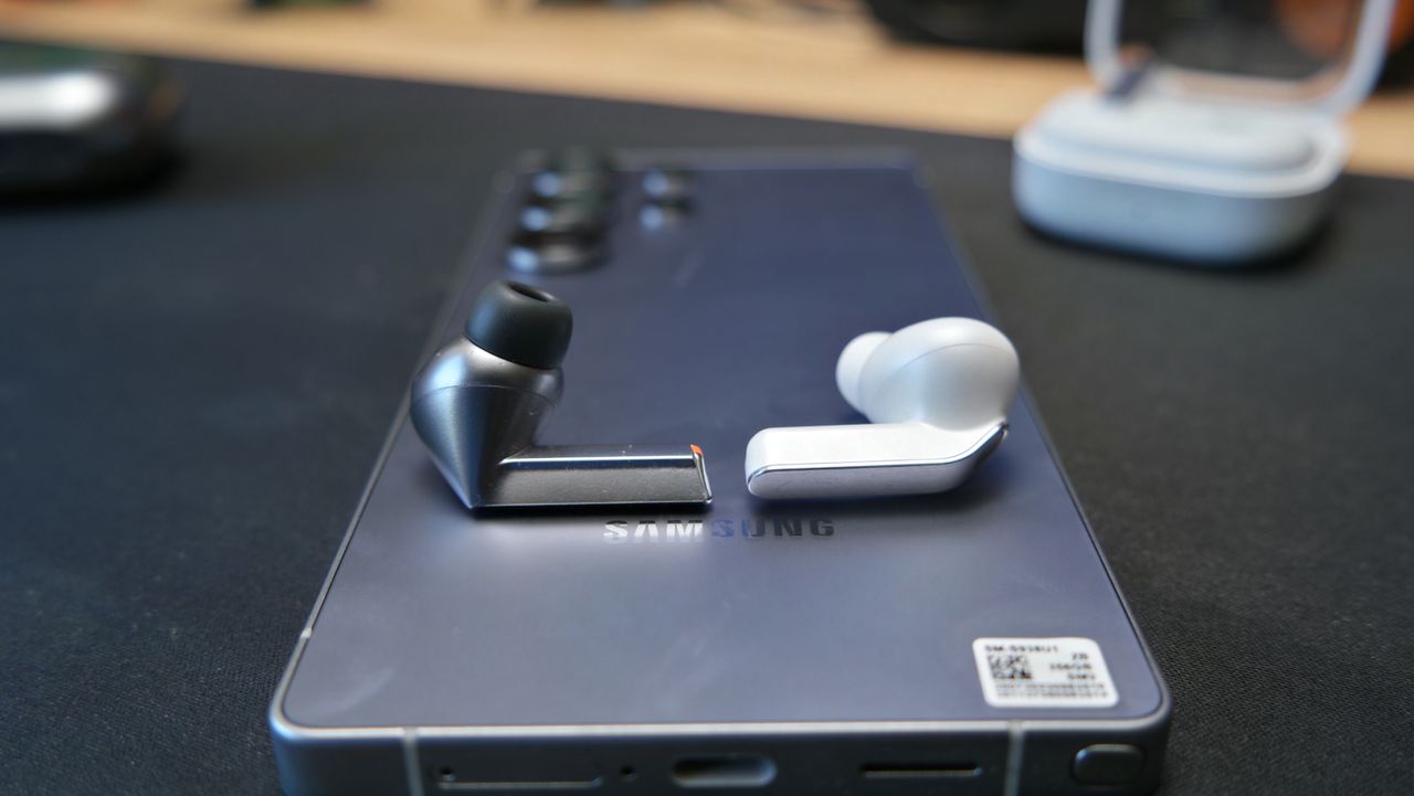 Galaxy Buds 4 Pro on a desk, next to Galaxy Buds3 Pro