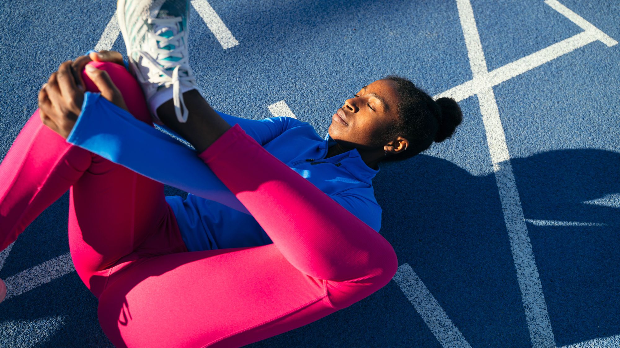 Best posture exercises: A woman stretching her legs on a track