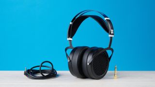 the HIFIMAN Sundara open-back wired audiophile headphones photographed against the blue toms' guide background