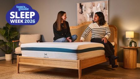Two Tom's Guide mattress testers sit on the Helix Twilight Mattress in our Sleep Product Testing Lab. A blue Sleep Week 2026 logo is overlaid in the top left hand corner