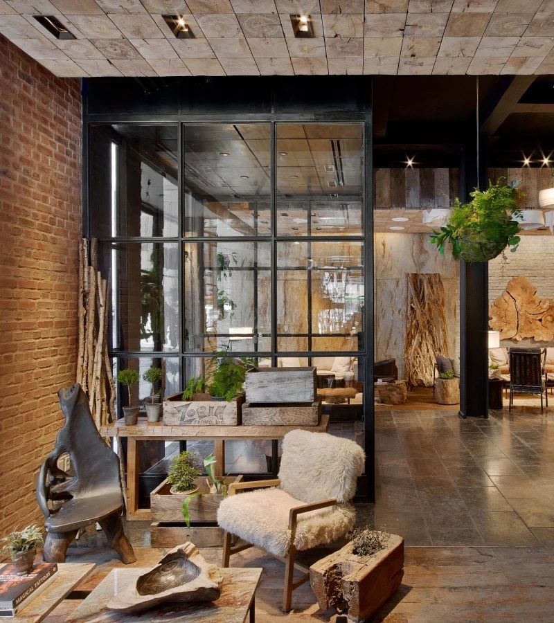 A nature-inspired hotel features wood-clad walls and trailing plants along with soft, wool furniture and cocooning interiors.