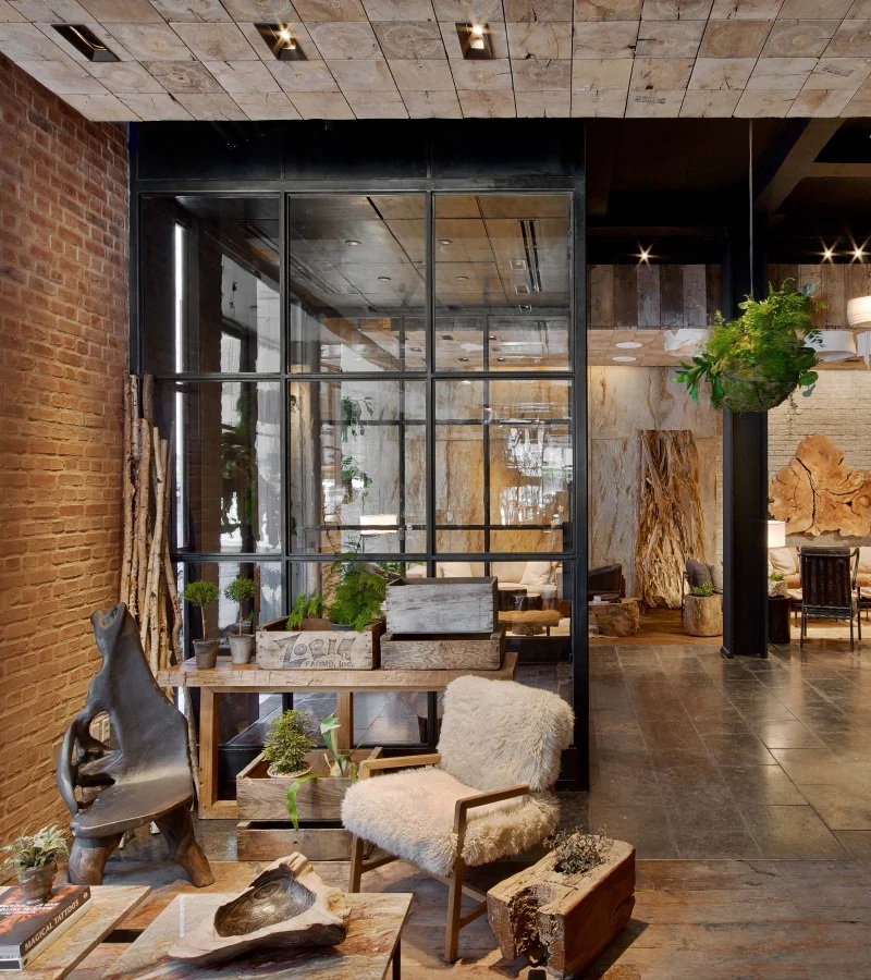A nature-inspired hotel features wood-clad walls and trailing plants along with soft, wool furniture and cocooning interiors.