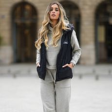 woman wearing a sweat set and a vest