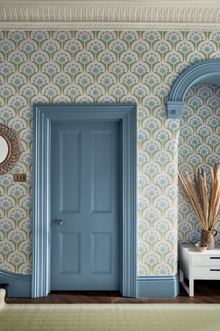 hallway with wallpaper and blue woodwork