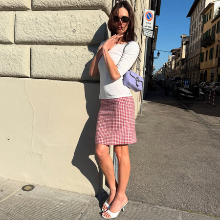 @devonleecarlson wearing the t-shirt and knee-length skirt outfit trend of spring 2026