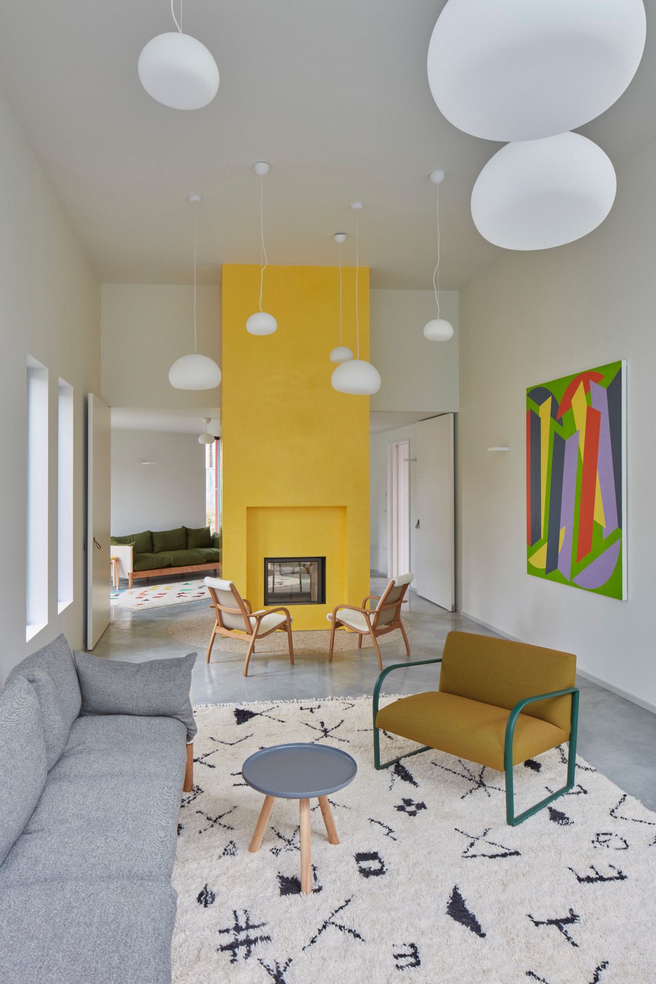 Maggie centre lounge with grey sofa, cream rug and yellow fireplace