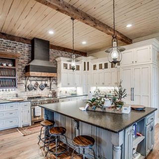 Kitchen with brick walls and white cabinet