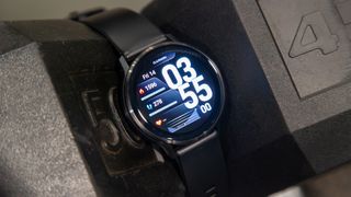 Garmin Venu 4 in between two dumbbells