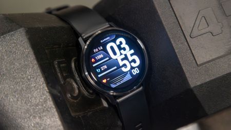 Garmin Venu 4 in between two dumbbells