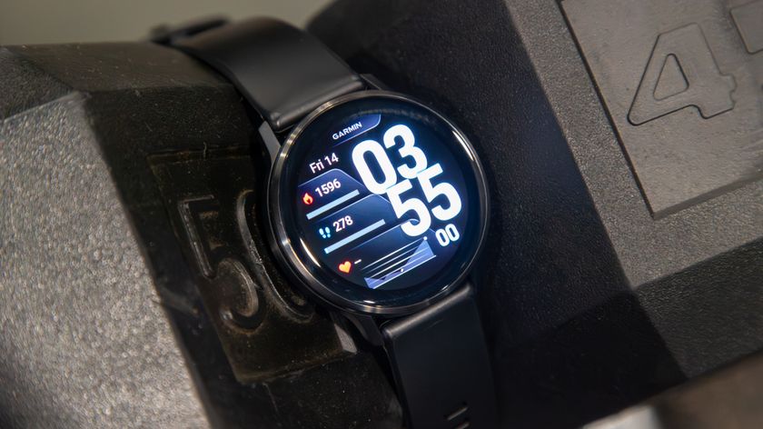 Garmin Venu 4 in between two dumbbells