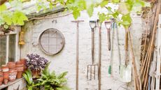 Garden tools hanging up on a wall