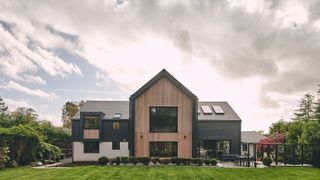 exterior of a large detached self-build home with a lawned garden