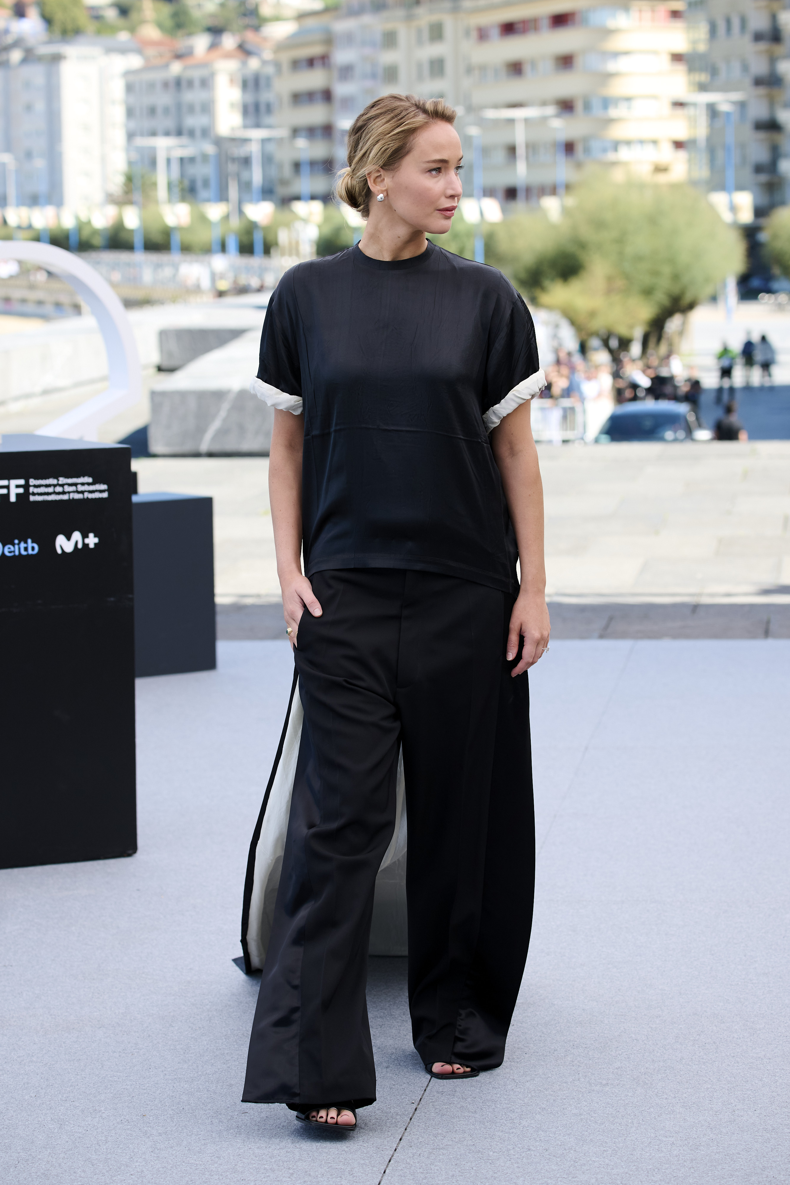 Jennifer Lawrence attended a film festival in spain wearing a T-shirt, pants, and a dress-like train