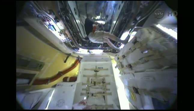 View inside SpaceX Dragon capsule at space station with cosmonaut Oleg Kononenko inside.