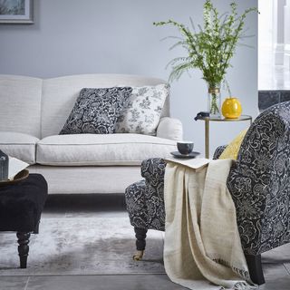 grey living room with white sofa and armchair