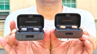Sennheiser Momentum TW3 and TW4 in charging case held in hand