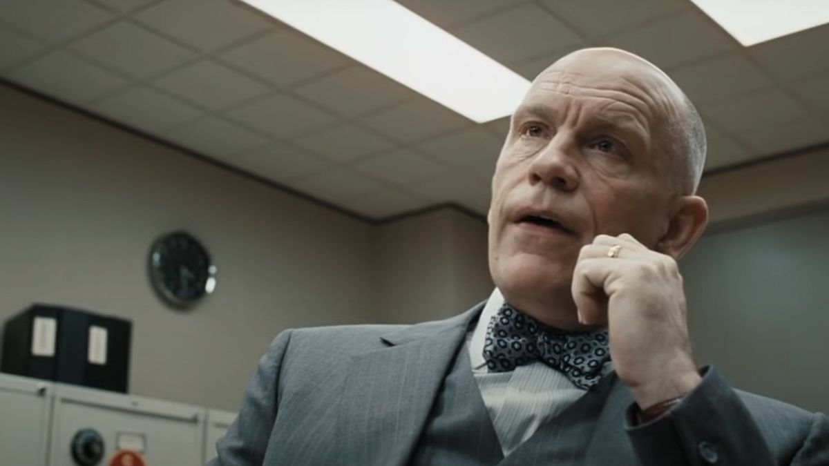 John Malkovich looking very upset while dressed in a very nice suit in Burn After Reading