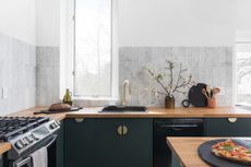 a dark kitchen with wooden countertops