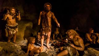 A museum reconstruction of a Neanderthal family in a cave