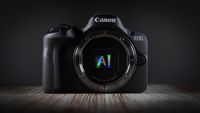 Canon camera, heavily silhouetted, with "AI" superimposed over its exposed sensor