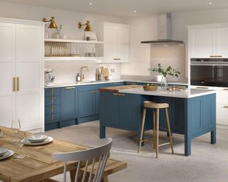 A white kitchen scheme with blue medium kitchen island size and blue cabinetry.
