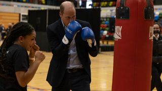 Prince William, Prince of Wales tries out boxing as attends the 10th Anniversary Celebration of Coach Core at Copper Box Arena on October 13, 2022 in London, England.