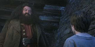 Hagrid, Harry and Professor Quirrell stand in the Three Broomsticks in 'Harry Potter and the Sorcerer's Stone'