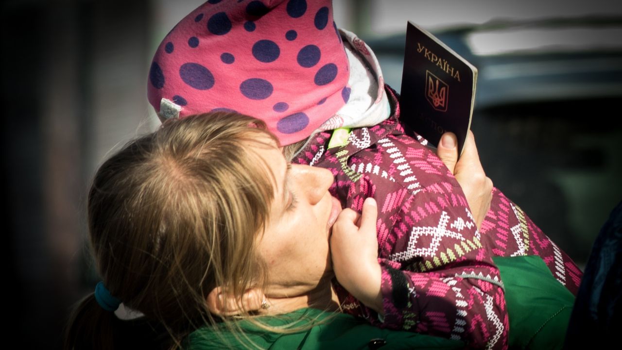 A mother holds her child at the refugee hub in Zaporizhzhia, Ukraine on 25 September