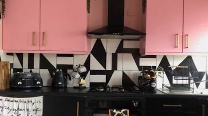 kitchen with pink cabinets and monochrome tiles
