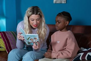 Ann Knight reading a story on the sofa to her young nephew Xavier Knight