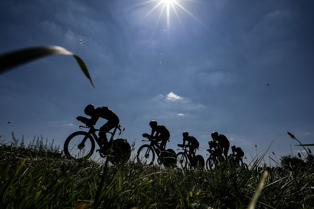 The sun shines on a formation in the team time trial at the Tour de France