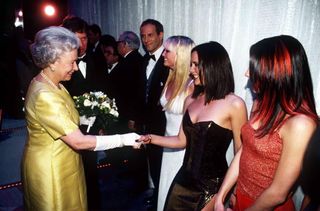 The Queen At The Royal Command Performance At The Victoria Palace Theatre On 1st December 1997 Shaking Hands With Pop Star Victoria Beckham (posh Spice) Of The Pop Band The Spice Girls