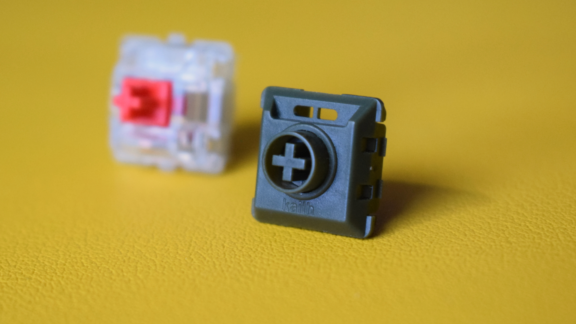 Photograph of Kailh Ghost low-profile linear mechanical switch next to Cherry MX2A silent red switch.