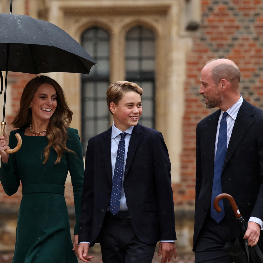 Princess Kate holding an umbrella, walking next to Prince George and Prince William