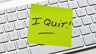 A post-it-note on a keyboard with the words 'I Quit!' displayed