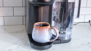 Keurig K-Brew+Chill pouring into a blue mug