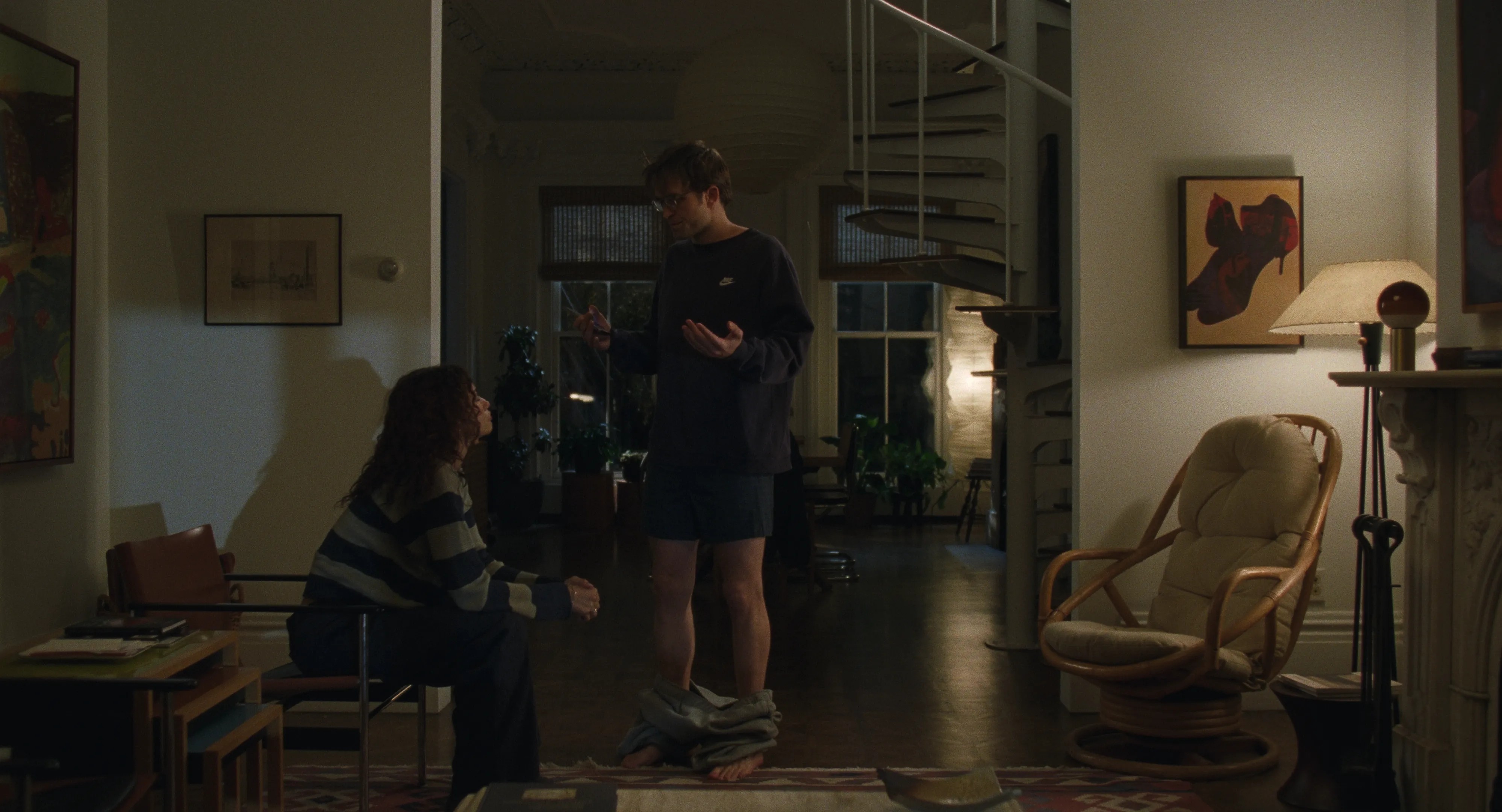 A series of interior shots of an apartment and museum filled with collectibles, canvases, dimly lit lamps, and books.