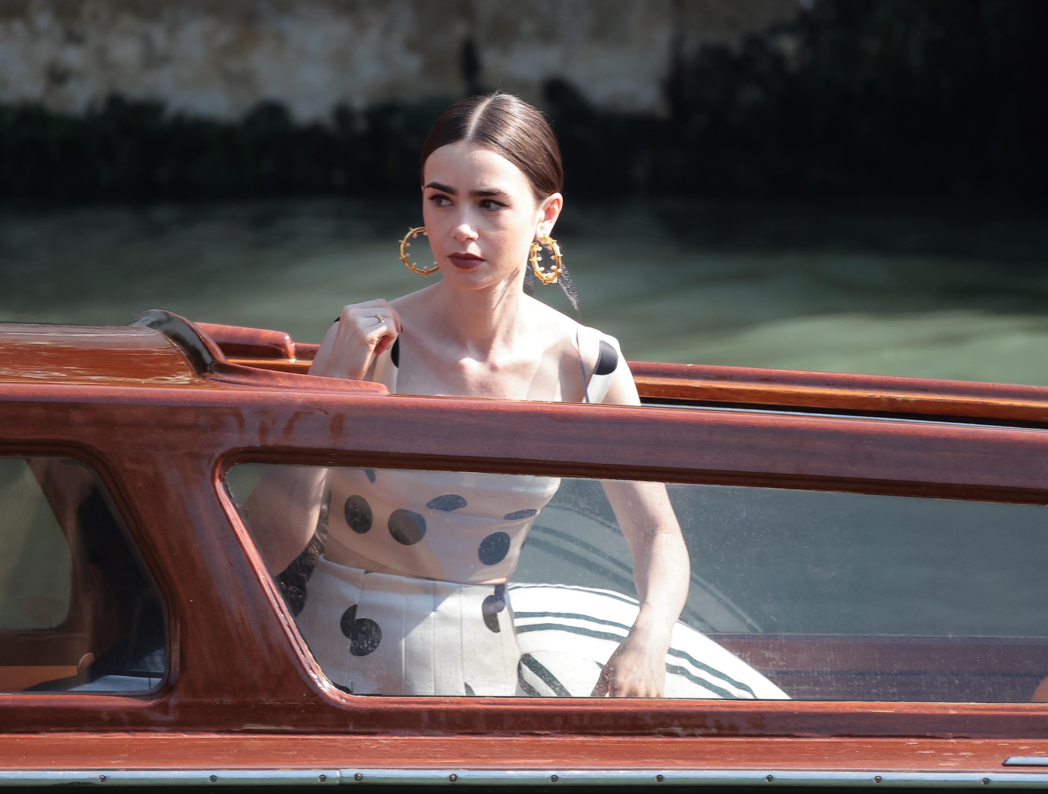 Lily Collins films Emily in Paris wearing a white and black polka dot dress