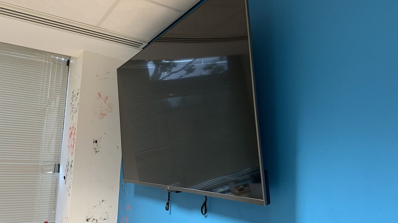The Mounting Dream (MD2268-LK-02) mounted on a wall with a TV hung on it