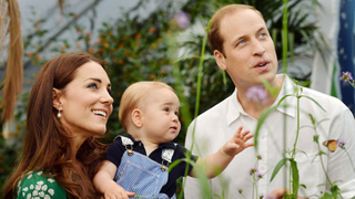 A photograph taken in London on Wednesday July 2, 2014, to mark Britain's Prince George's first birthday, shows Prince William (R) and Catherine, Duchess of Cambridge (L) with Prince George during a visit to the Sensational Butterflies exhibition at the Natural History Museum in London