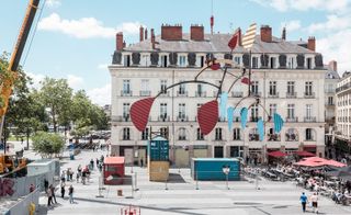 A gigantic Calder-esque mobile next to a building