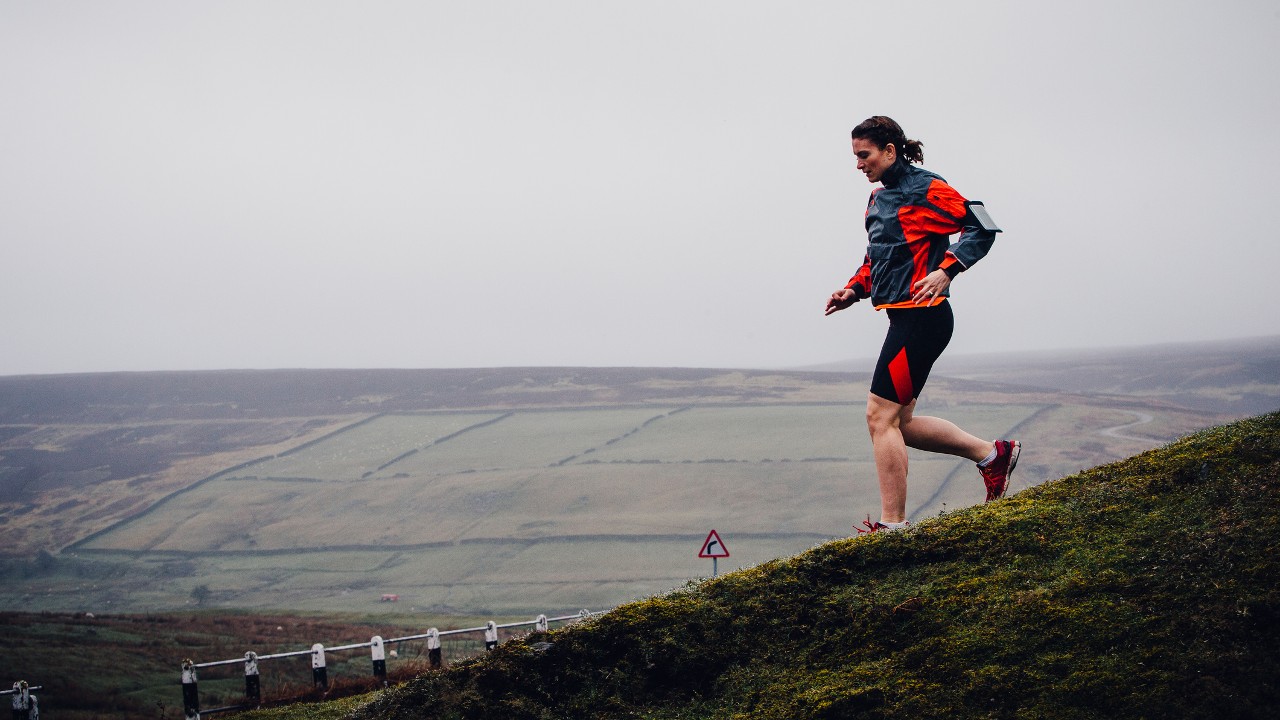 Woman runs downhill