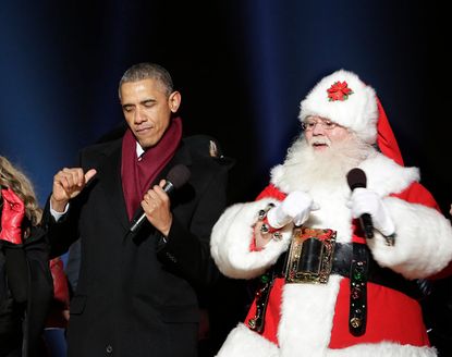 President Obama dances with Santa Claus during the lighting of the National Christmas tree in 2014.