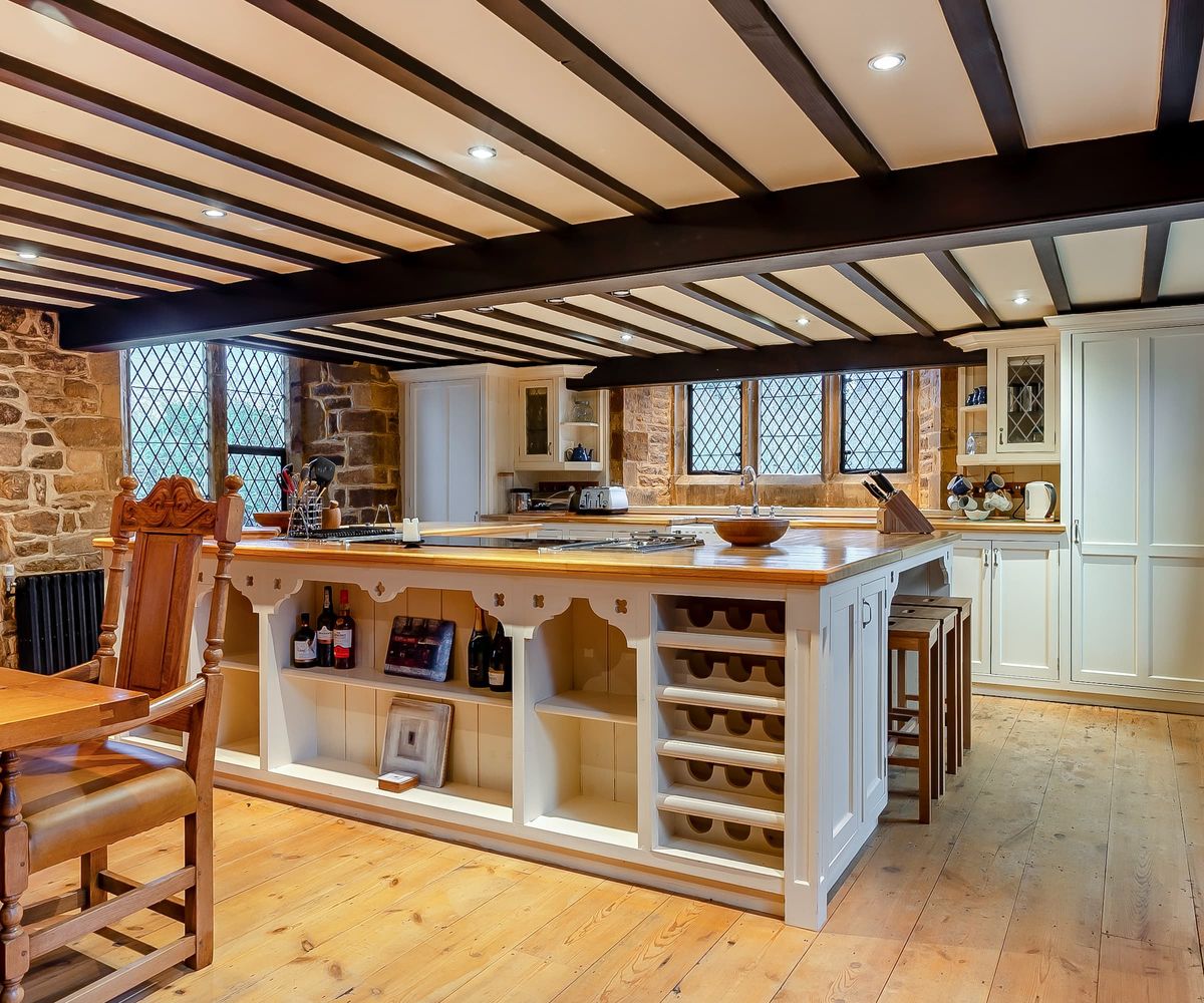 A white kitchen island with bespoke fitted units